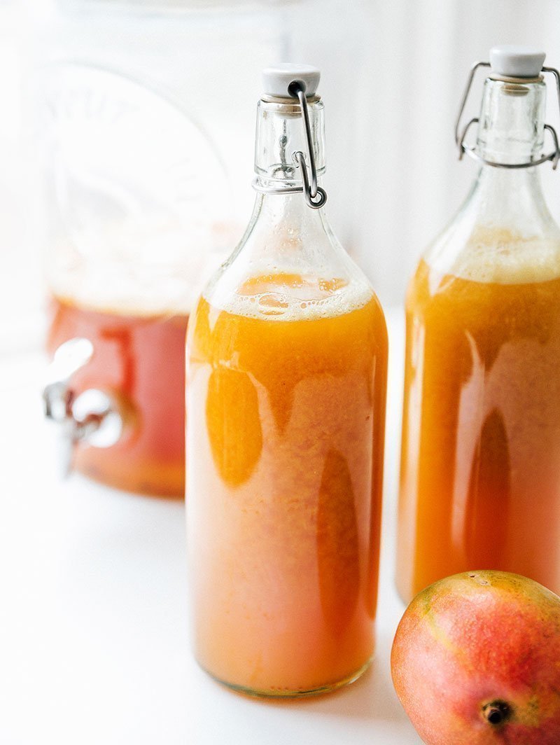 kombucha in bottles with a mango