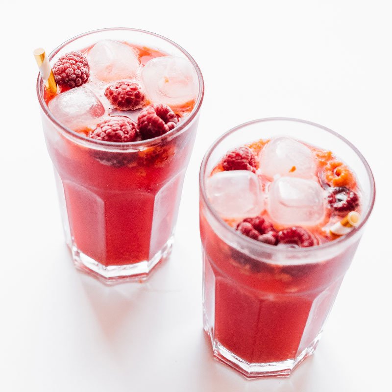 Trilogy copycat raspberry lemon kombucha in glasses on white background