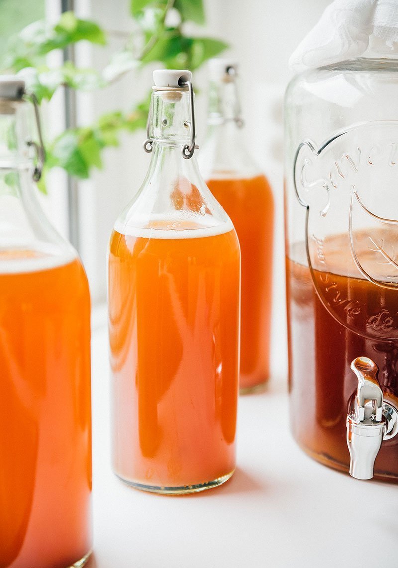 Bottle of kombucha on a white counter