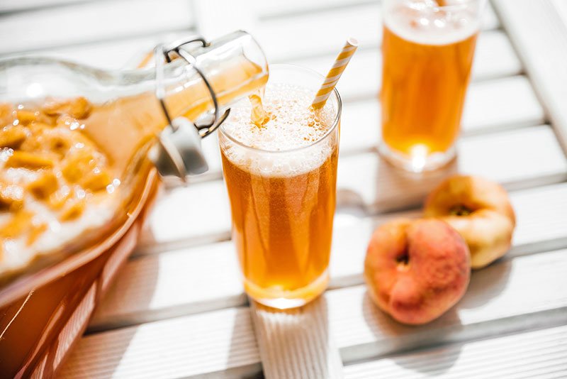 pouring kombucha into a glass