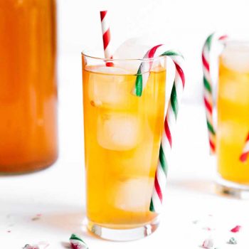 Kombucha in a glass with a candy cane