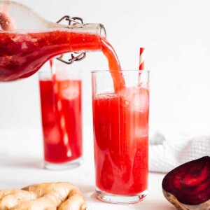 Pouring beet kombucha into glass