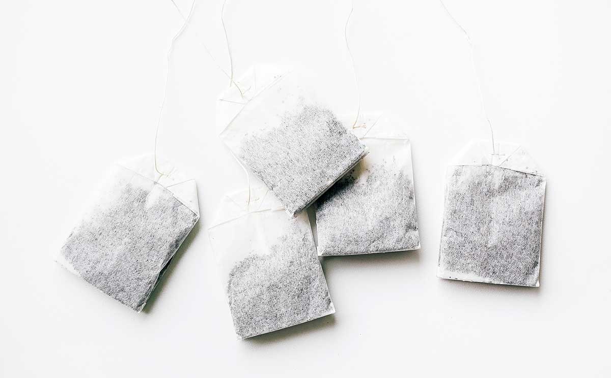 Black tea bags on a white background