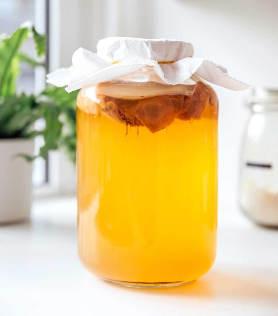 Jar of green tea kombucha with a SCOBY