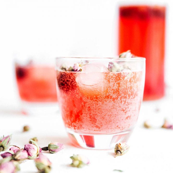Carbonated rose kombucha in a glass on a white background