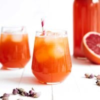 Blood orange kombucha in a glass on a white background