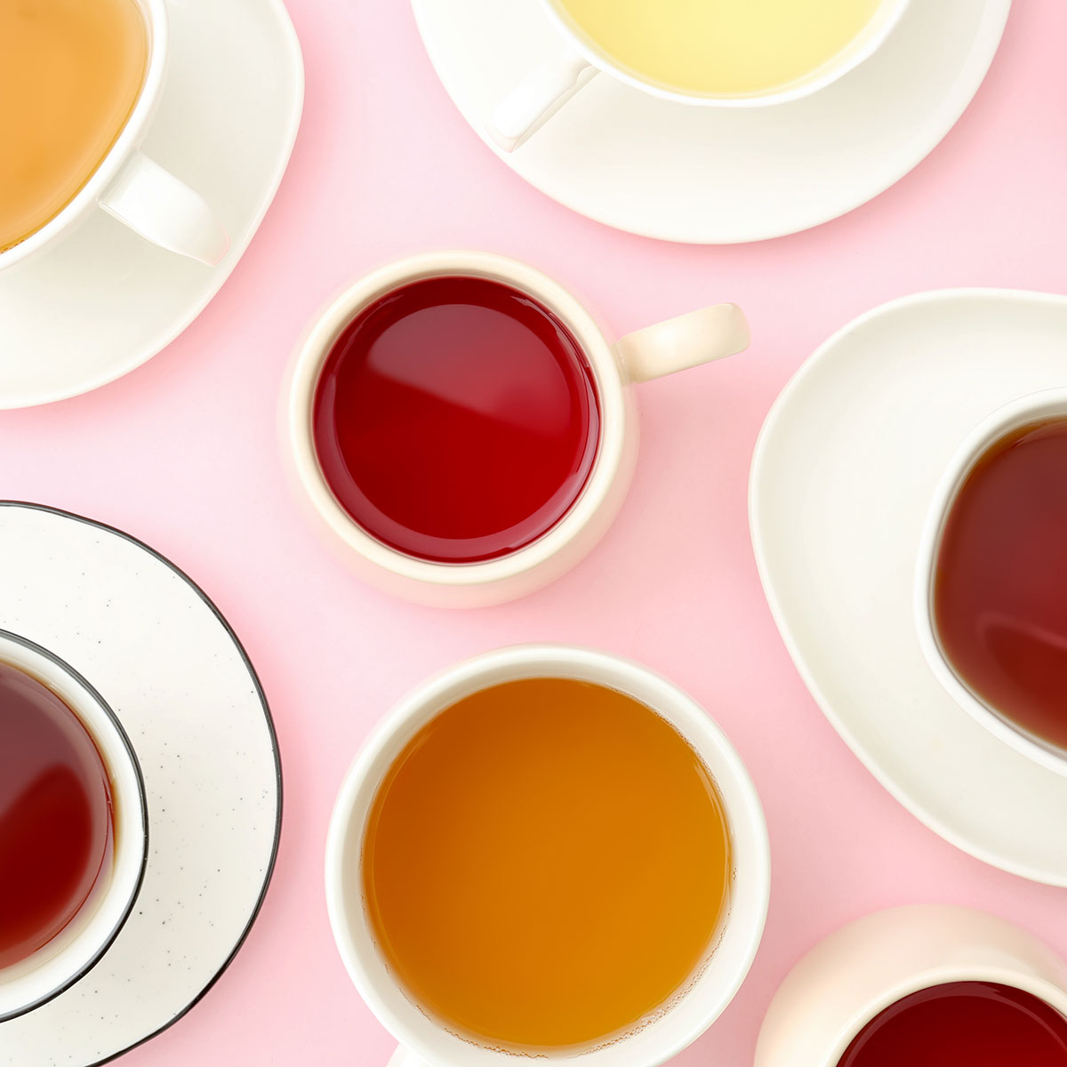 Many types of tea on pink background.