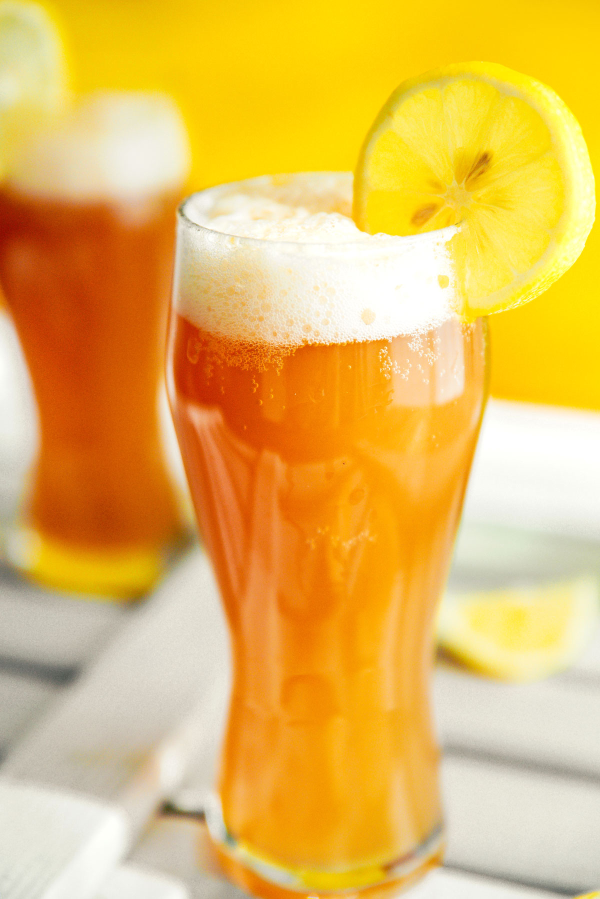 Kombucha beer shandy in a glass with a lemon